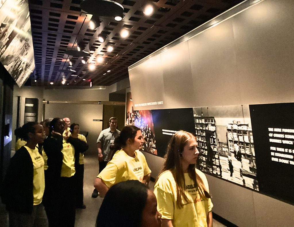 2026 participants walking through a museum exhibition.