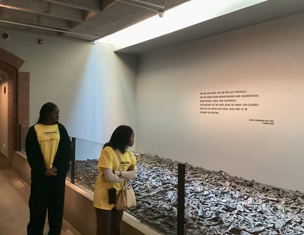 Two participants viewing the shoe memorial at the United States Holocaust Memorial Museum.
